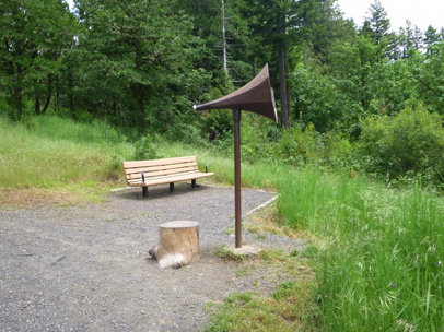 Park bench with a megaphone type hearing device, located on Blacktail Way